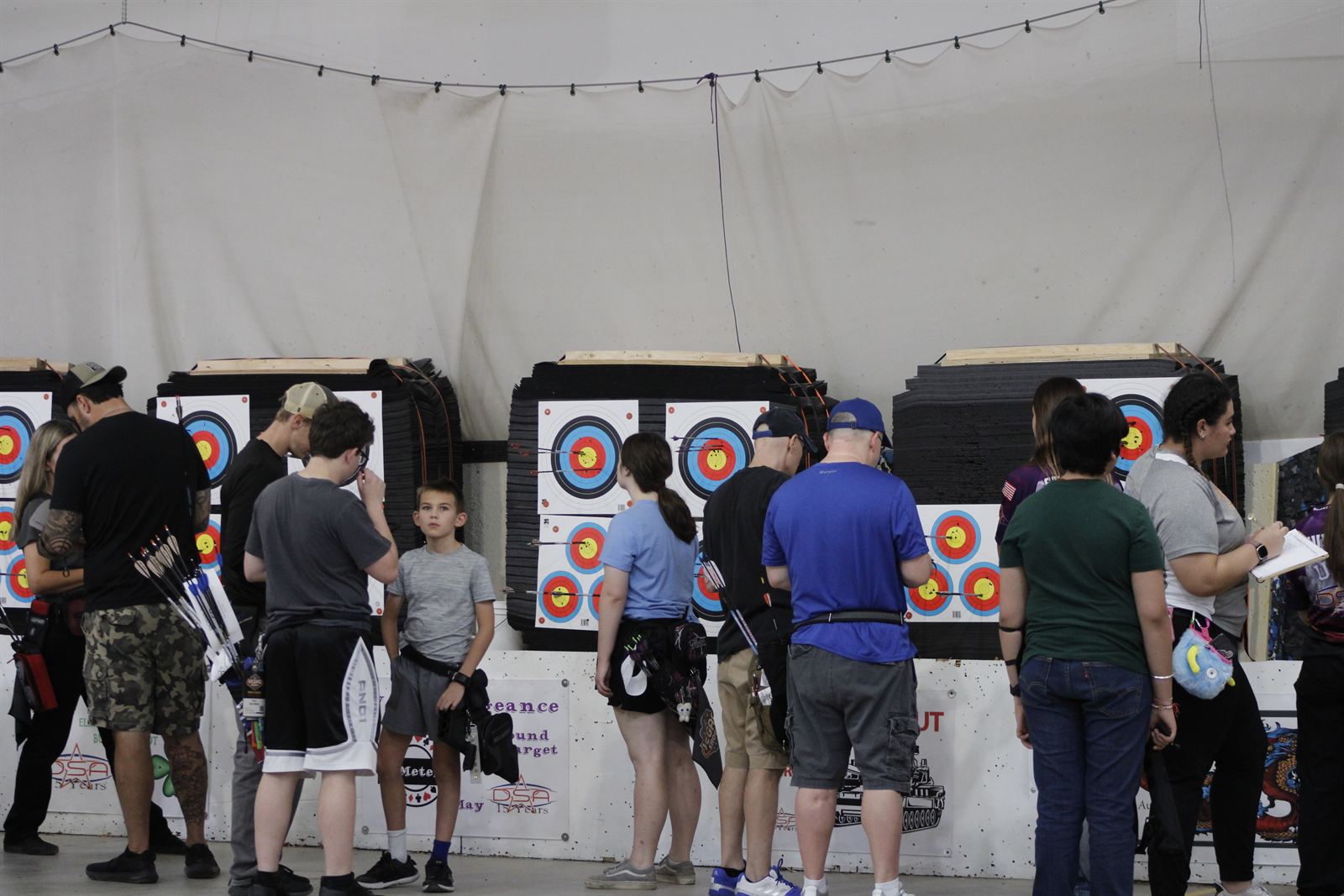 Archers and a young shooter at the line during drop-in practice at Ben Avery